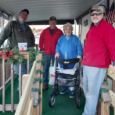 Ramp recipient with volunteers on a Ramps of Hope ramp